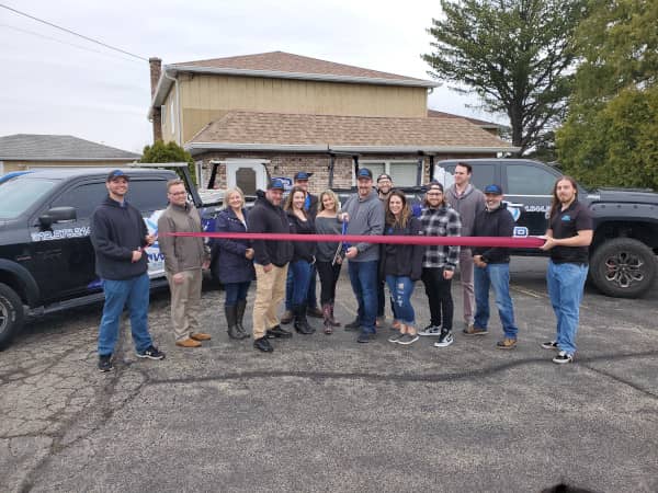 A ribbon cutting ceremony at Renowned Building Solutions 