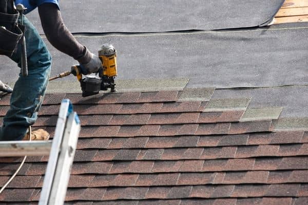 Shingle installation during the roofing process step by step