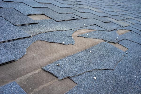 Torn shingles upon a roof