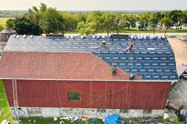 Roofing contractors do work on a commercial roof