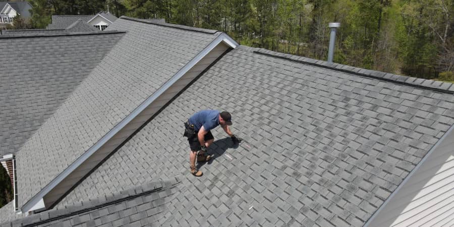 Worker performing a residential roofing project
