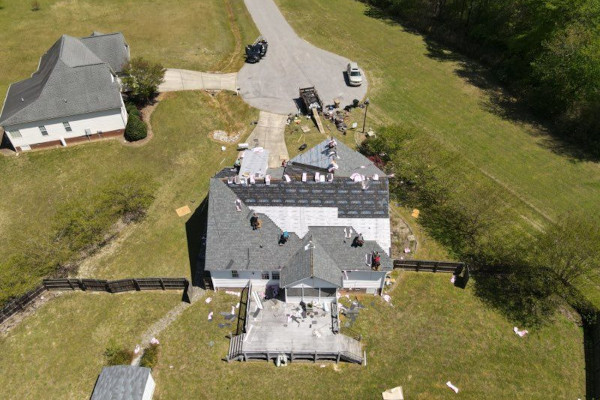 Aerial view of roofers working on a residential roof